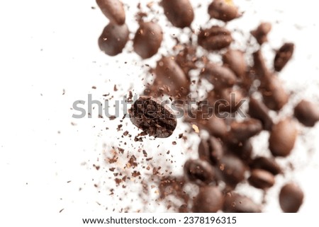 Coffee bean powder fly explosion, Coffee crushed ground float pouring, wave like smoke smell. Coffee bean powder splash throwing in mid Air. White background Isolated selective focus blur