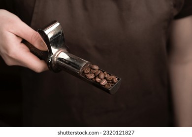 Coffee bean sampler is held in hand, roasted beans are shown