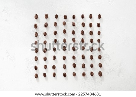 coffee beans arranged symmetrically on a white background, rows and pattern