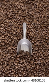 Coffee beans background with a spoon