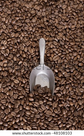 Coffee beans background with a spoon