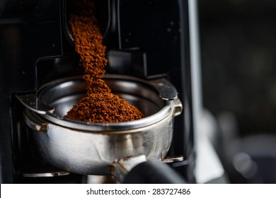 Coffee beans being grinded from machine