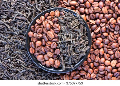 Coffee Beans And Black Tea Leaves In A Round Saucer