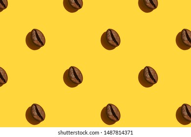 Coffee Beans Creative Pattern On Yellow Background. Top View.