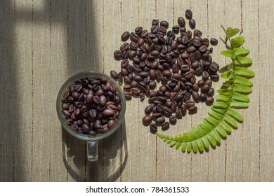 Coffee beans with cup on the table and copy space. Coffee café.