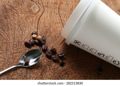 Coffee beans coffee cup and spoon on old hard wood represent coffee business concept related idea . Super macro shot and intention focus at the cup. - Shutterstock ID 282513830