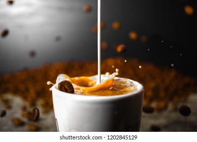 Coffee Beans Falling While Creamer Mixes With Coffee