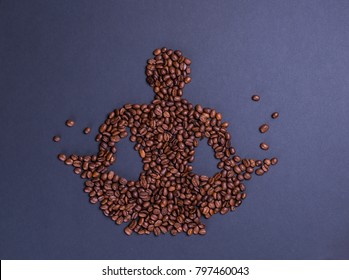 coffee beans in the form of a man who sits in yoga lotus pose on grey mat surface and levitate