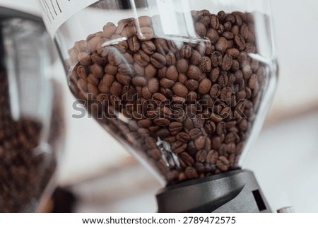 Coffee beans in a coffee grinder for coffee makers for customers