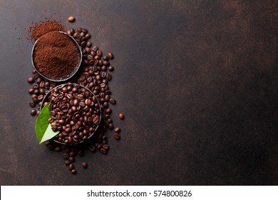 Coffee beans and ground powder on stone background. Top view with copy space for your text  - Shutterstock ID 574800826
