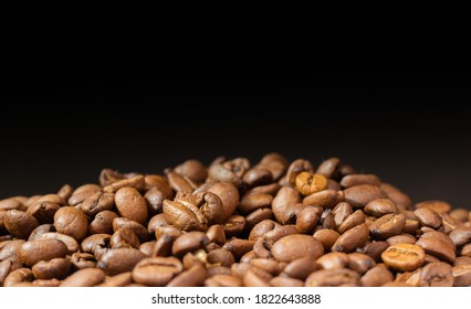 Coffee beans on a black background. Heap of coffee beans. Poured coffee close-up. - Shutterstock ID 1822643888
