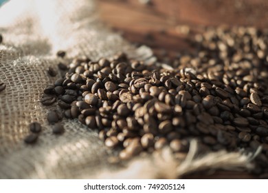 coffee beans on a table with burlap.