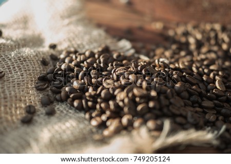 coffee beans on a table with burlap.