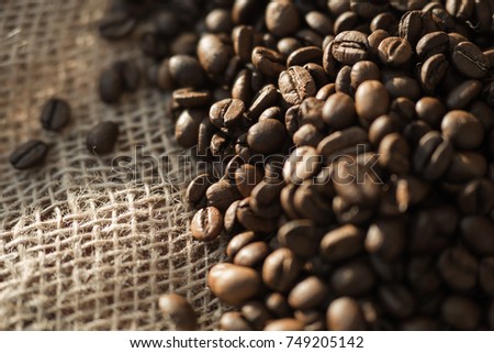 coffee beans on a table with burlap.