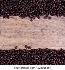 Coffee beans on wood background - Shutterstock ID 228015859