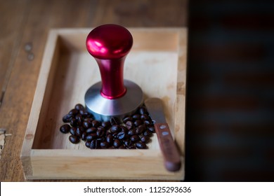 Coffee beans and portafilter with knife on wooden box. - Powered by Shutterstock