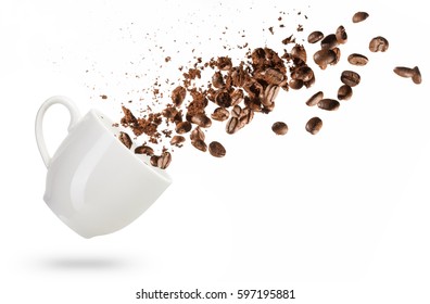 Coffee Beans Spilled Out Of A Cup Isolated On White Background