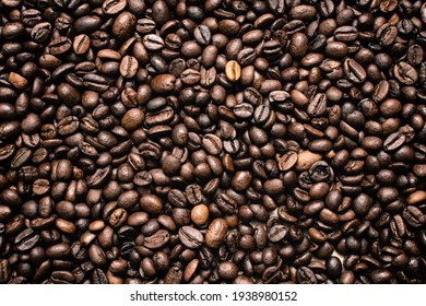 Coffee beans. Coffee beans are spread out on the surface. - Shutterstock ID 1938980152