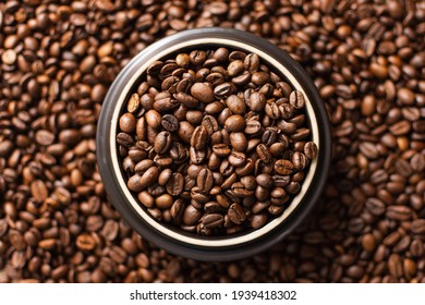 Coffee beans. Coffee beans are spread out on the surface. - Shutterstock ID 1939418302