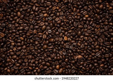 Coffee beans. Coffee beans are spread out on the surface. - Shutterstock ID 1948220227
