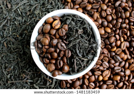 coffee beans and tea in leaves on the same plate
