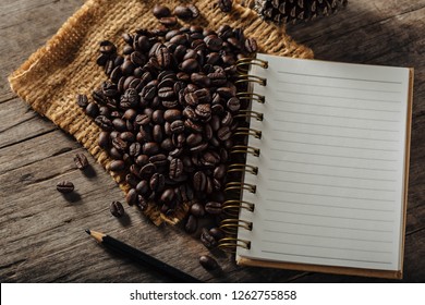 coffee beans withe note book on wooden table