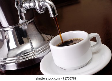 Coffee Being Poured From Vintage Silver Urn