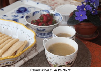 Coffee break with delicious sponge cookies and fresh strawberries - Shutterstock ID 2310776279