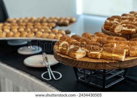coffee break hotel during conference meeting, corporate revent with tea and coffee catering, decorated catering banquet table with variety of different pastry and bakery, with croissants and cookies