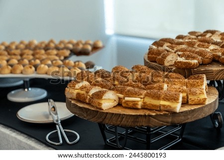 coffee break hotel during conference meeting, corporate revent with tea and coffee catering, decorated catering banquet table with variety of different pastry and bakery, with croissants and cookies