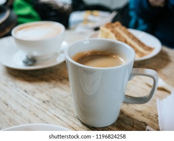 Coffee Break In A Small Cup And A Piece Of Cake After A Full Day Walking Around