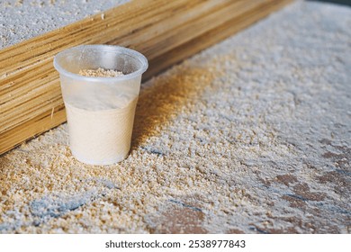 Coffee break, tea time in workshop.A plastic cup,sawdust,carpenter's workbench - Powered by Shutterstock