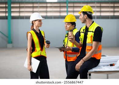 coffee break together in warehous. Ethnic diversity worker people, Success teamwork. Group of professional engineering people wearing hardhat safety helmet meeting - Powered by Shutterstock