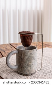 Coffee Brew With Individual Cloth Strainer In A Mug Made Of Stone On A Wooden Table.