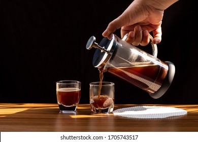 Coffee brewing in a French press pot and two donuts in plate on the wood table and warm morning light, Selective focus. - Powered by Shutterstock