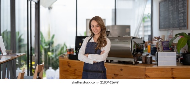 Coffee Business owner Concept - attractive young beautiful asian barista with apron in coffee shop counter. - Powered by Shutterstock