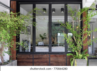 Coffee cafe exterior and front store decorated with wood panel and eco furniture design