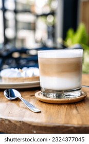Coffee and cake on a cafe table outside. Morning, drink, good mood concept