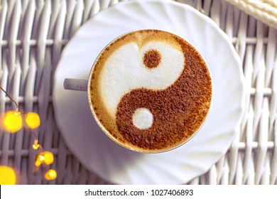 coffee cappuccino in a white cup with a symbol of dao on milk foam