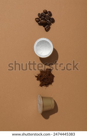 Coffee capsules and beans on brown background, space for text