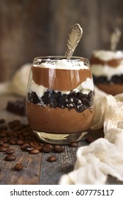 Coffee Chocolate Mousse With Cookies And Whipped Cream In A Glass On Rustic Wooden Background.