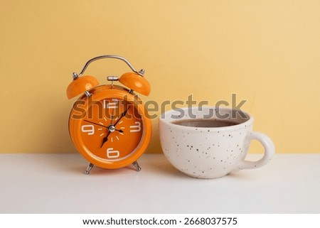 Coffee and clock on a colored background.  Time to drink coffee. Break time. Creative idea.