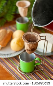 Coffee Cloth Strainer And Hot Water On Coffee Table.