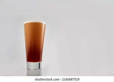 Coffee cold brew nitro coffee, cold ice latte with fresh milk pouring. Glass of ice cafe latte isolated on white background