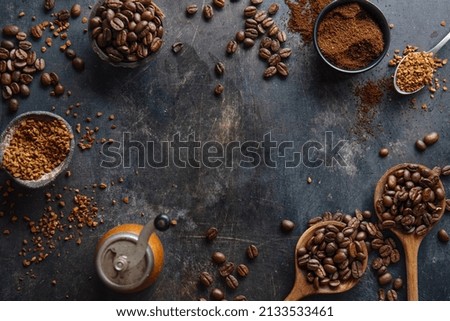 Coffee concept with differents types of coffee, coffee beans, milk and cinnamon sticks on grey background. Flat lay