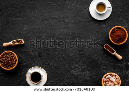 Coffee concept. Roasted beans, ground coffee, cup of espresso and sugar on black background top view copyspace
