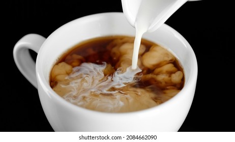 Coffee Creamer. Pour Cream In Black Coffee Close Up