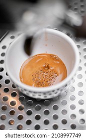 Coffee Crema Drip In White Cup On Espresso Machine, Close-up Top View