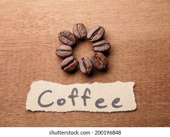 Coffee crop beans with text paper on wood texture background