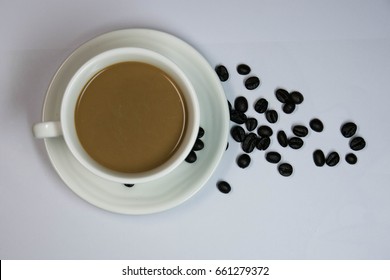 coffee cup and coffee bean on table white
